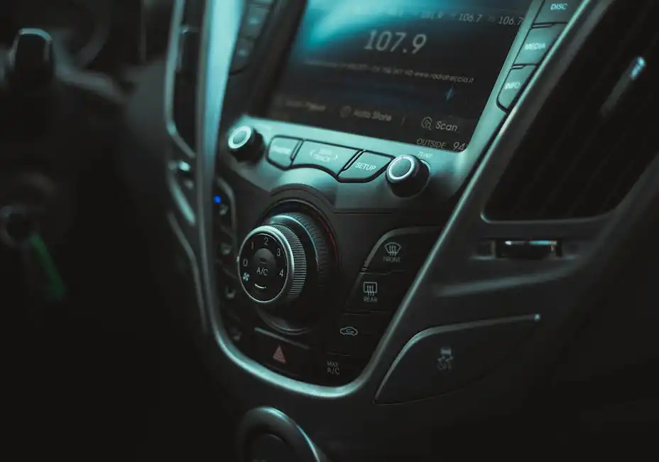 Photo of a Car Interior with a Radio, Buttons and Air Vent