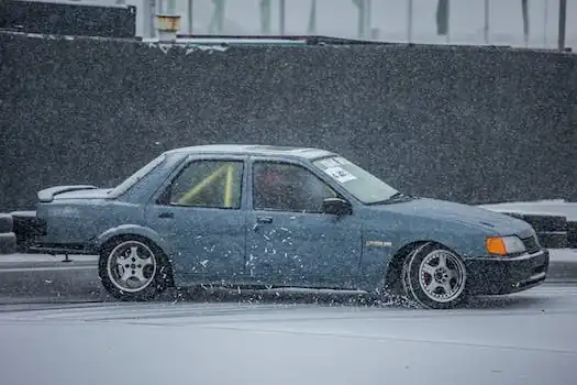 drift car rides on the track covered with snow