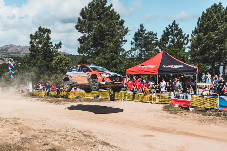 A thrilling rally car in midair during a crowded motorsport event in Sardinia, Italy.