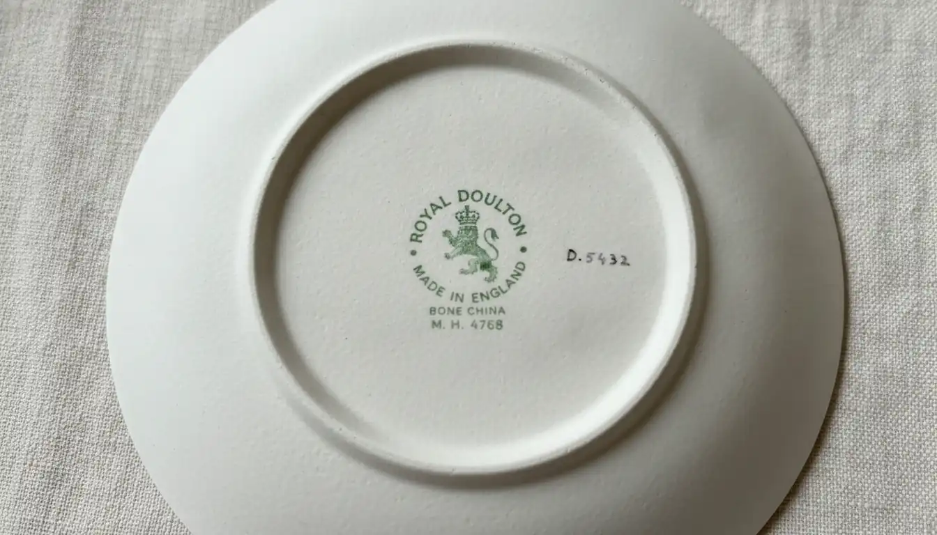 Close-up of a Royal Doulton backstamp on the bottom of a porcelain piece, showing the lion and crown logo.